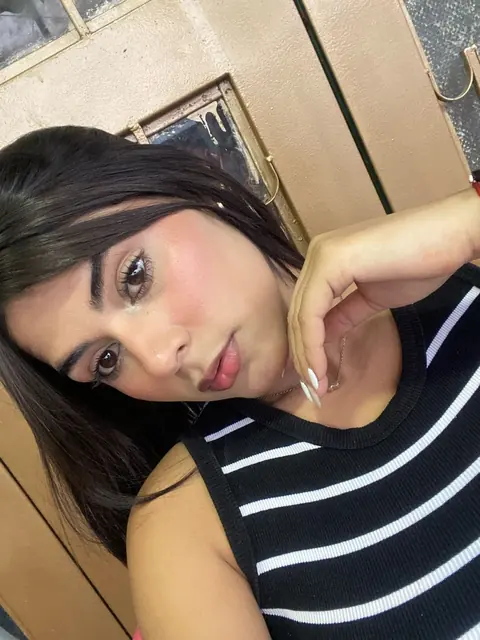 Woman in a striped top tilting her head