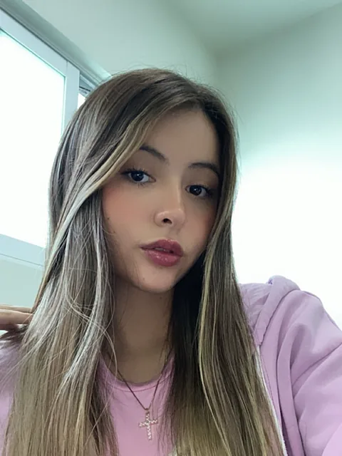 Woman with highlighted hair in a lilac hoodie