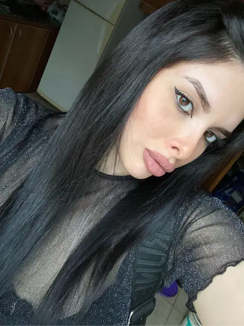 Woman with long black hair in a mesh top
