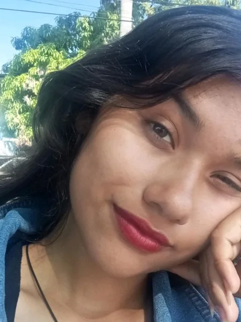 Woman resting her chin on her hand and smiling
